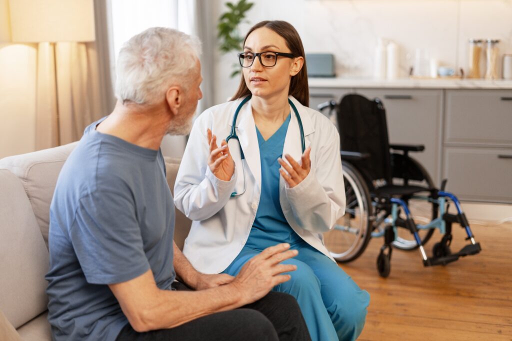 Female doctor explaining diagnosis to senior patient at home